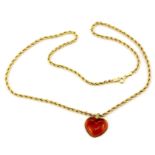 A hallmarked 9ct yellow gold chain and yellow metal heart shaped pendant, chain L. 49cm.