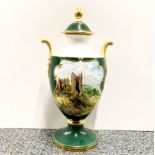 A handpainted and signed Caverswall porcelain urn and lid.