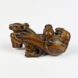 A signed carved fruitwood netsuke of a family of rats, L. 5cm.