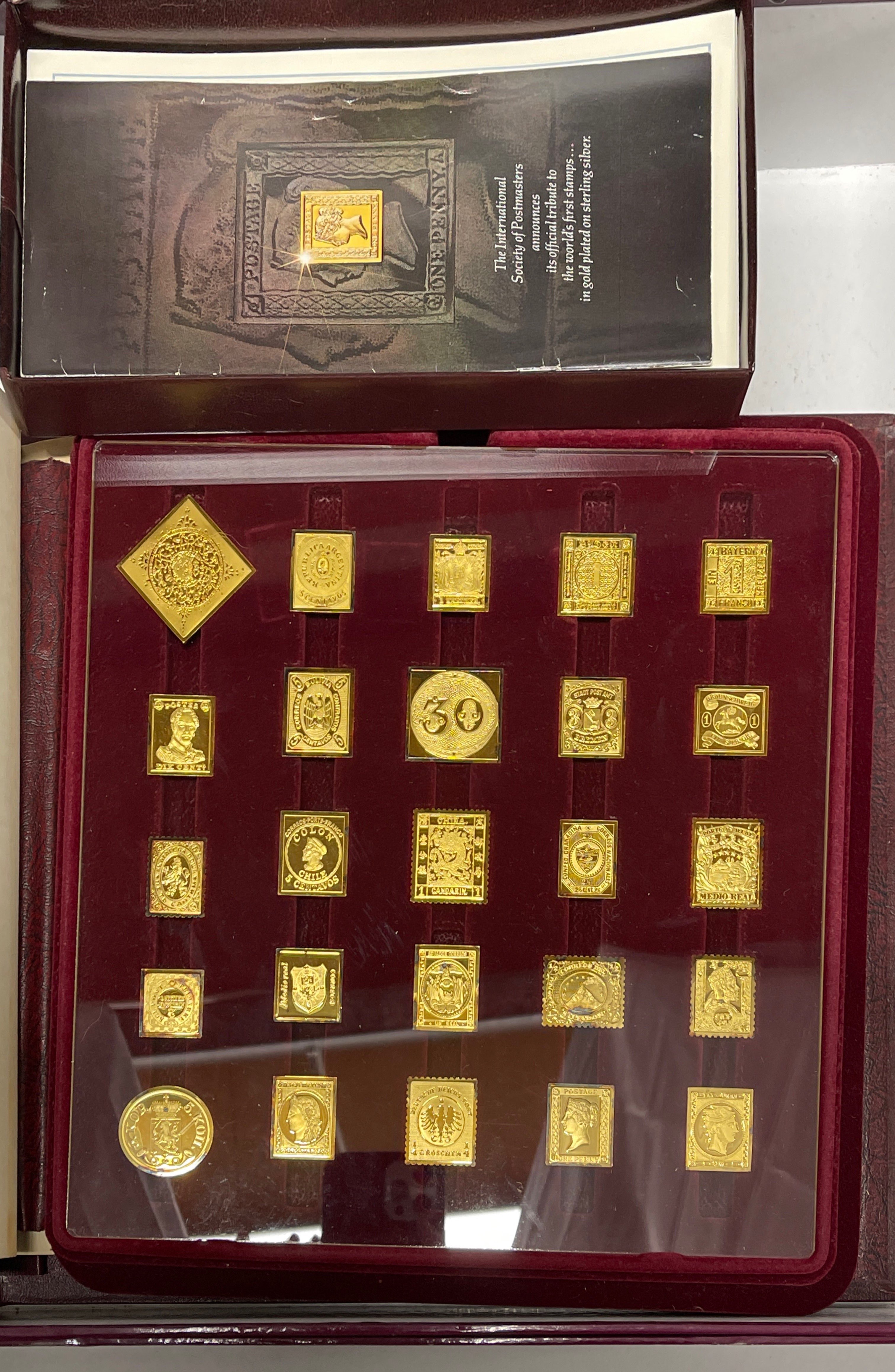 An album of gold on silver world stamp proofs (42 out of 73 pieces) with certificates.