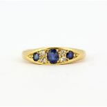 An 18ct yellow gold sapphire and diamond set ring, (M).