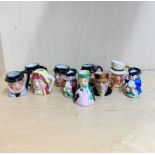 A collection of miniature porcelain character jugs, tallest H. 4cm (various makers).