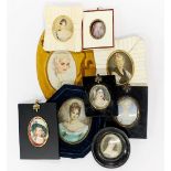 A group of framed portrait miniatures.