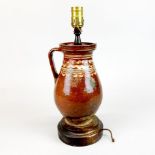 An early pottery jug mounted as a table lamp, H. 39cm. Pottery A/F.