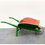 A mid 20th C child's wooden wheelbarrow by L. Bros, slightly A/F, L. 82cm.