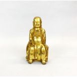 A Tibetan gilt bronze figure of a seated deity, H. 24cm.