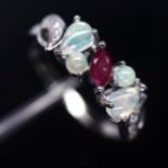 A matching 925 silver ring set with opals, rubies and white stones, (O.5).