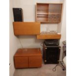 A four piece 1970's wall mounted teak desk and cabinet system with glass shelving and brackets,