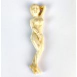 A Chinese carved bone naked female figure, L. 12cm.