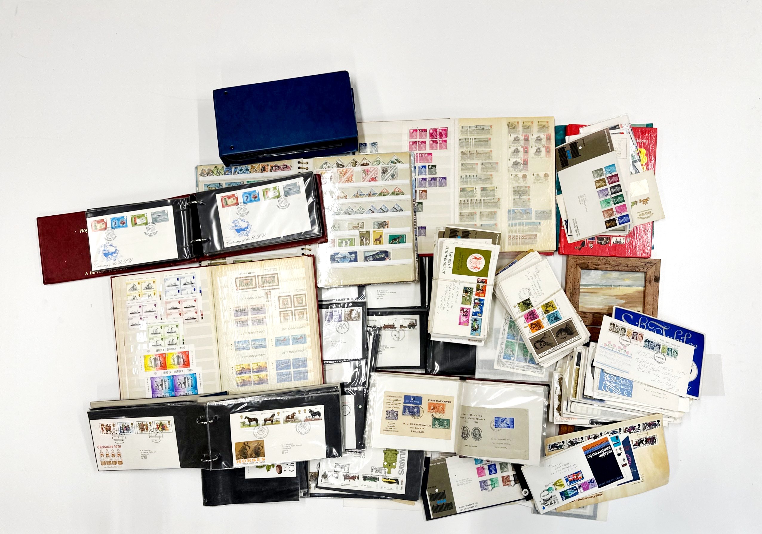 A large box of mixed stamp albums and first day covers.