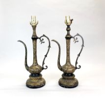 A pair of early 20th century Middle Eastern mounted, engraved and laquered brass jugs on ornate