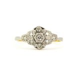 An Art Deco 18ct gold and platinum diamond set ring, (S).