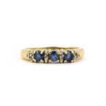 An 18ct yellow gold ring set with round cut sapphires and diamonds, (N).