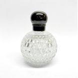 A hallmarked silver topped cut glass dressing table bottle with screw on lid, H. 15cm.