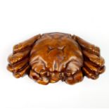A Chinese carved fruitwood model of a crab holding a 'cash' W. 6.5cm.