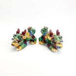 A pair of glazed Chinese dragons, L. 21cm H. 14cm.