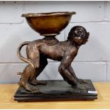 A bronze figure of a monkey mounted with a bowl on his back on a black marble base, 37 x 20 x 40cm.