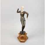 An Art Deco style bronze figure of a lady on a marble base, H. 36cm. A/F to two fingers (both