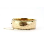 A heavy hallmarked 9ct yellow gold bangle, L. 6.5cm.