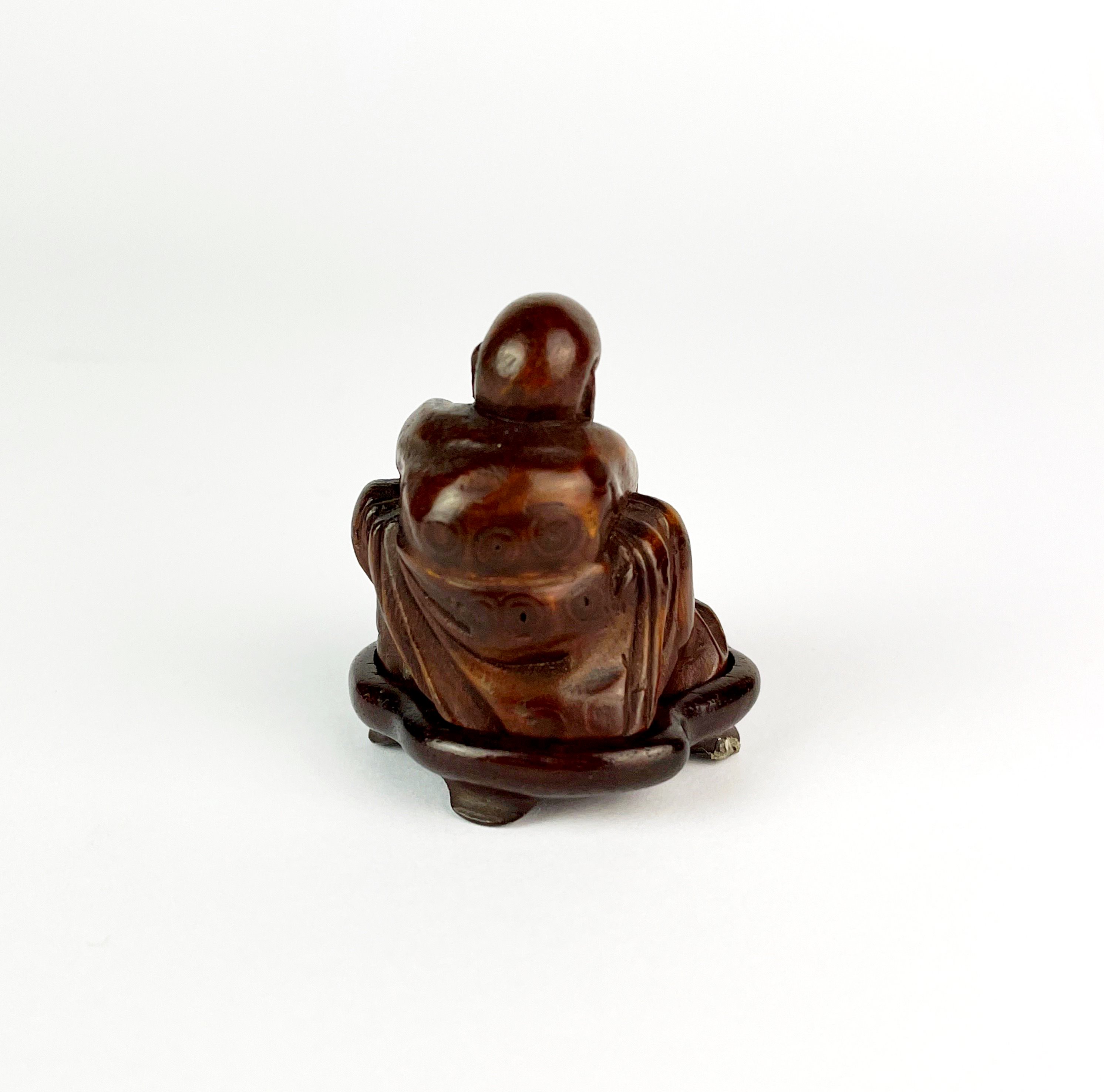 A finely carved Chinese bamboo figure of a man holding a peach with a carved wooden base, H. 5cm. - Image 2 of 2