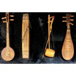 Four mounted wooden miniature Chinese musical instruments, 46 x 30cm.