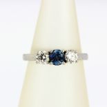A 950 platinum ring set with a blue stone flanked by brilliant cut diamonds, approx. 0.5ct diamonds,