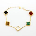 An 18ct yellow gold bracelet set with tiger's eye, mother of pearl, onyx, malachite and cornelian,