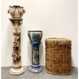 A Capodimonte style plant stand, a Chinese plant stand and cane linen basket.