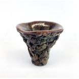 A Chinese carved libation cup, W. 15cm, H. 13.5cm.