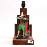 A 19th century painted cast iron figure of Guy Fawkes mounted on an oak table lamp, overall H.