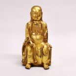 A Tibetan gilt bronze figure of a seated deity, H. 24cm.