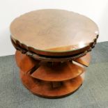 An interesting circular coffee table with figured walnut veneer and plate glass top with four
