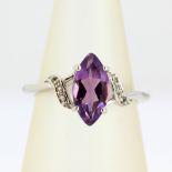 A 9ct white gold ring set with a marquise cut amethyst and diamonds, (N).
