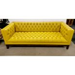 A large three seater contemporary faux leather, button backed settee, L. 215cm. Small split to one