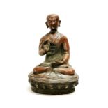 A 19th / early 20th century Tibetan bronze figure of a seated Buddha, H. 26cm.