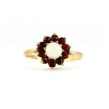 A 9ct yellow gold opal and garnet set cluster ring, (P.5).