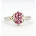 A 9ct white gold ring set with fancy pink sapphires and diamonds, (N).