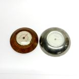 A Georg Jensen wall thermometer, Dia. 14cm together with a further thermometer.