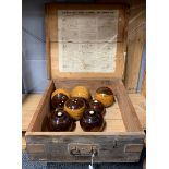 A vintage wooden box of wooden bowls.