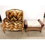 A French style upholstered armchair together with a cane footstool, chair W. 95cm.