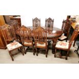 A Victorian carved oak extendable/ wind out dining table on castors with eight matching carved oak