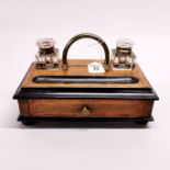 A 19th century Japanned and crossbanded walnut desk stand with cut glass inkwells, 24 x 15 x 13cm.