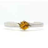 A 9ct white gold solitaire ring set with a fancy yellow sapphire, (N).