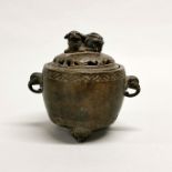 A 19th / early 20th century Chinese bronze censer with elephant head handles and mounted with a