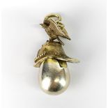 A Russian hallmarked and gilt helmet, eagle and egg pendant H. 5cm.