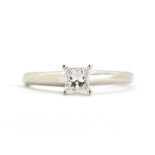 A 14ct white gold (stamped 14k) solitaire ring set with a princess cut diamond, (J).
