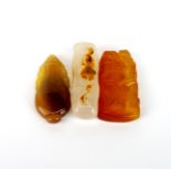 Three Chinese carved agate amulets, longest L. 5cm.