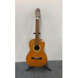 An acoustic guitar and stand.