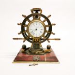A rare W. Thornhill & Co, Newburn Street London ships wheel style gilt brass clock with ratchet base