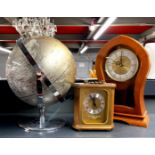 A vintage globe, H. 30cm, together with two mantle clocks.